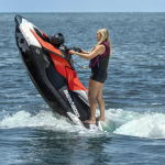 Red Sea-Doo Spark Trixx jet ski floating on clear blue water